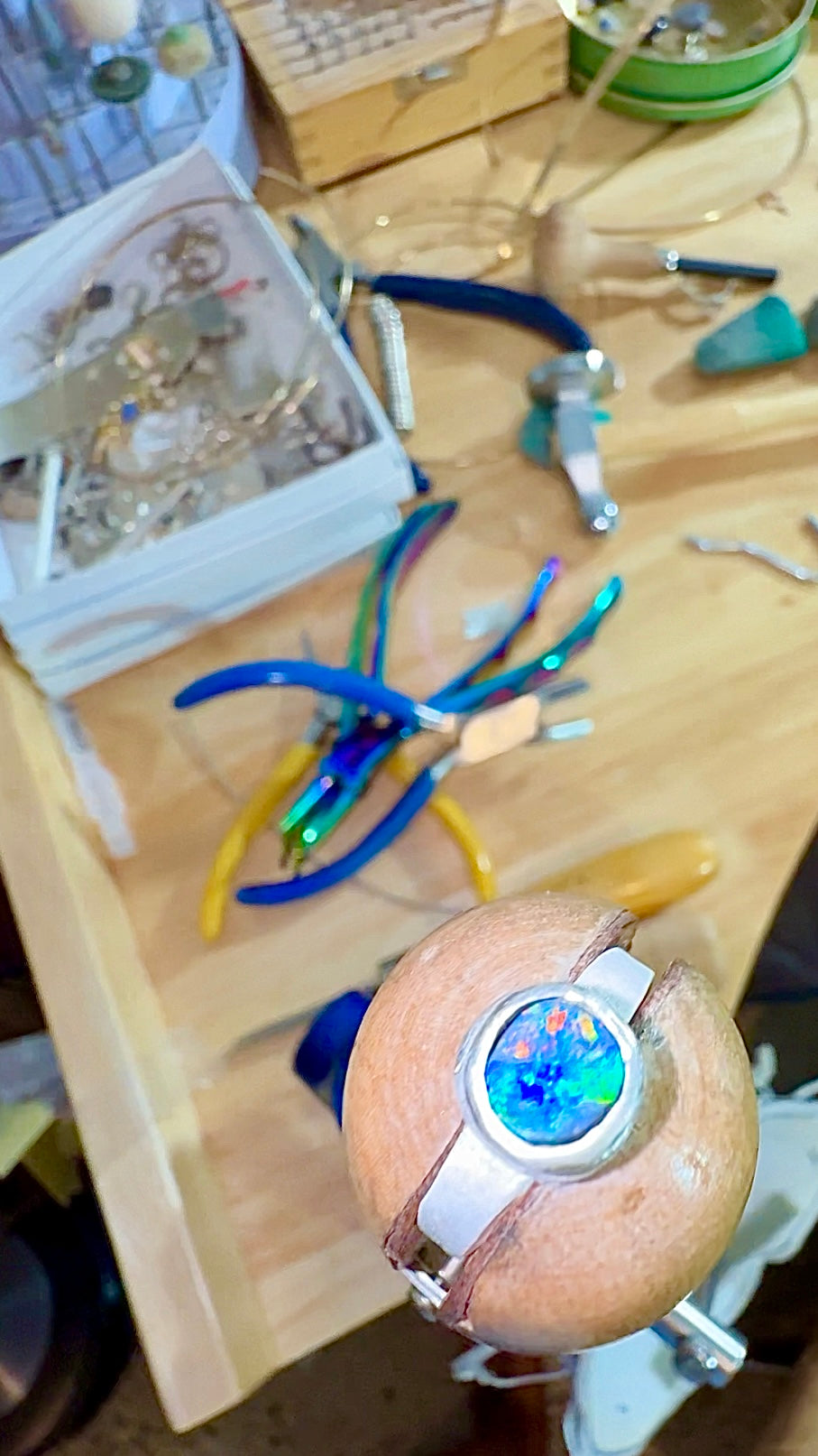 Bench setting a bright blue black opal silver ring. Solid, natural, Australian opals set in handcrafted precious metals.