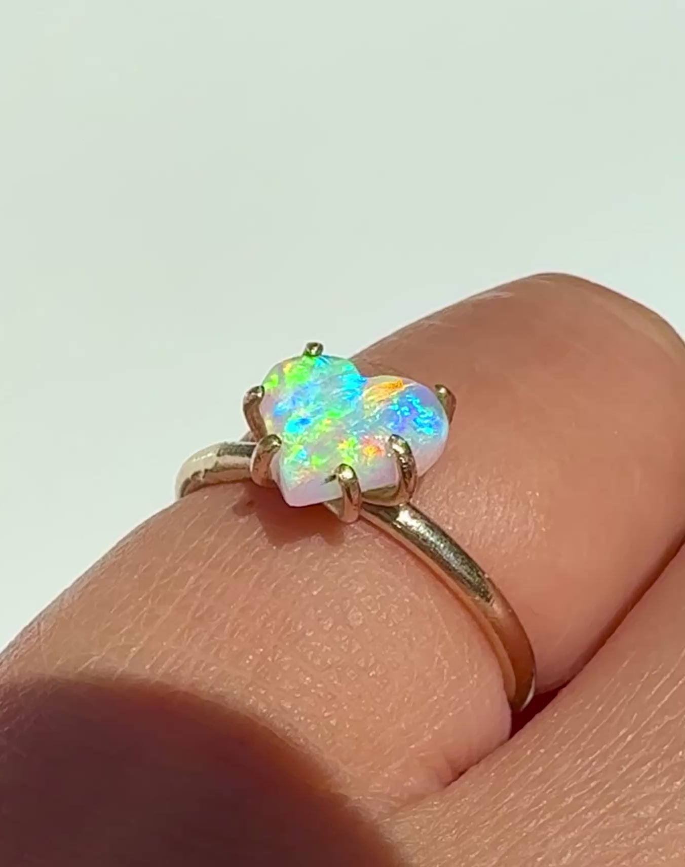 Wearing the Rainbow Heart natural Australian crystal opal solid gold ring in the sunlight.