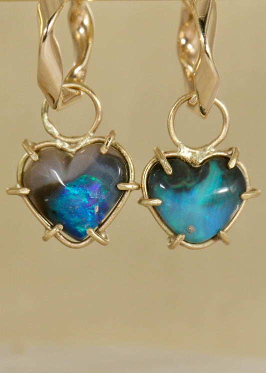 Black Opal Blue Heart earring charms in solid 9ct gold hanging on a pair of slight twist 9ct gold earrings (front view)